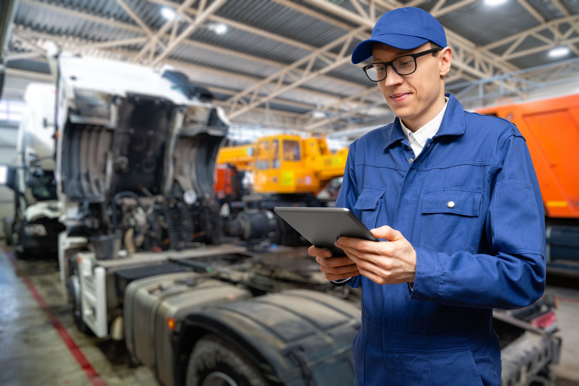 Serviceman with digital tablet on the background of the truck